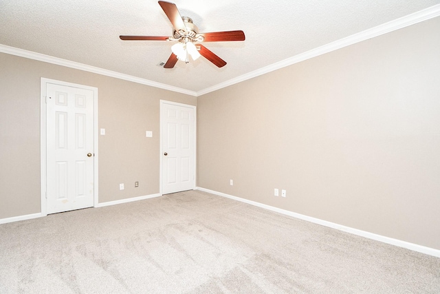 unfurnished room with crown molding, carpet flooring, baseboards, and a textured ceiling