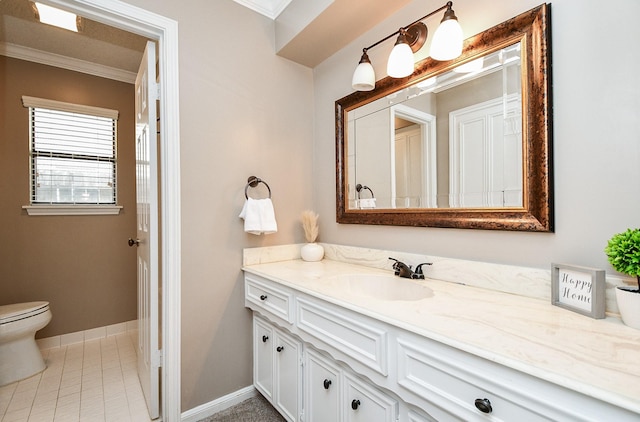 bathroom with vanity, baseboards, ornamental molding, tile patterned floors, and toilet