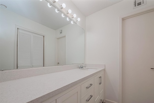 bathroom featuring visible vents and vanity