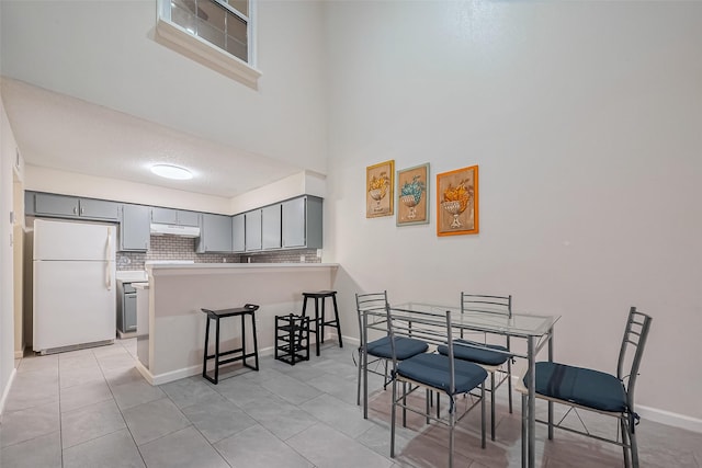 dining area with light tile patterned floors and baseboards