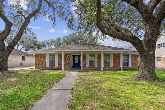 ranch-style home featuring brick siding, a porch, and a front lawn