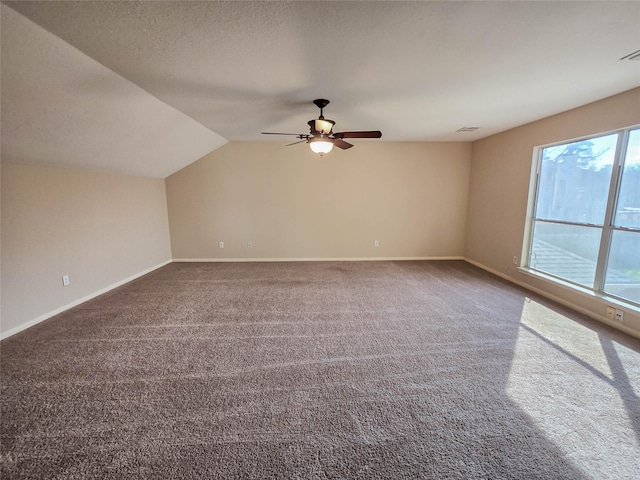 bonus room with baseboards, a textured ceiling, carpet, and vaulted ceiling