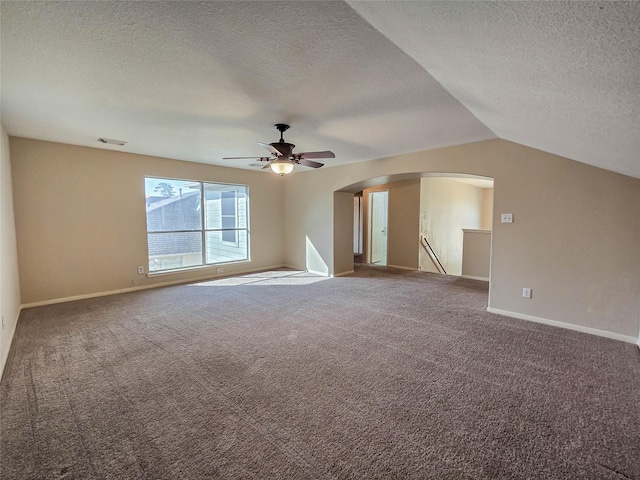 unfurnished room featuring visible vents, lofted ceiling, carpet floors, arched walkways, and baseboards