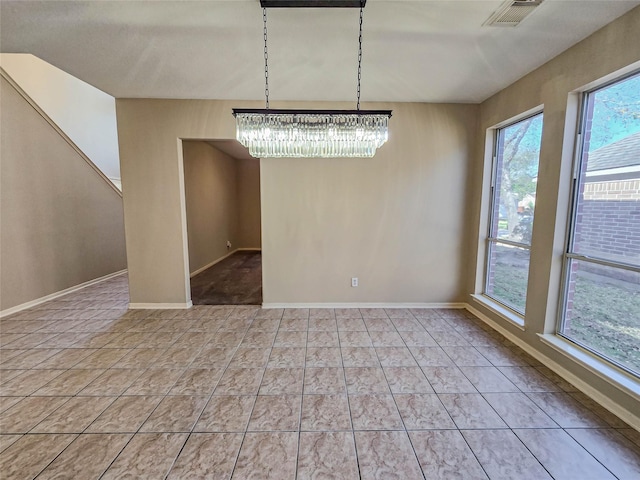 unfurnished dining area with a notable chandelier, baseboards, and visible vents