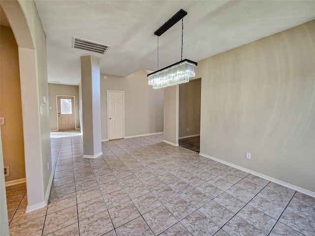 spare room featuring arched walkways, visible vents, baseboards, and light tile patterned flooring