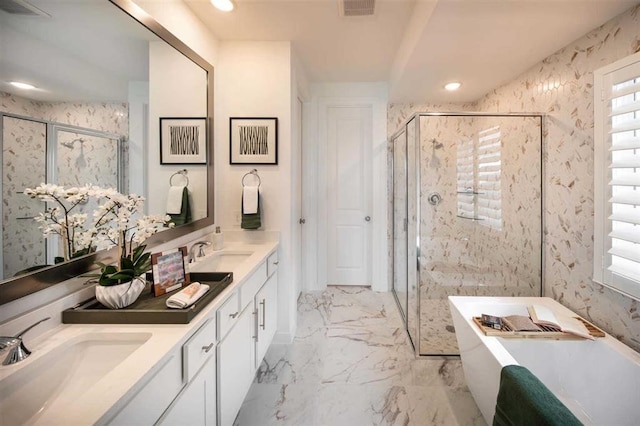 bathroom with a sink, a freestanding tub, marble finish floor, and a shower stall