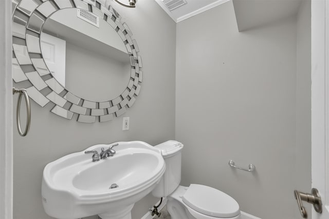 bathroom with a sink, visible vents, baseboards, and toilet