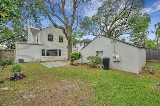 back of property featuring a patio area, central AC unit, a lawn, and fence