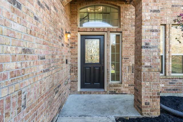 property entrance with brick siding