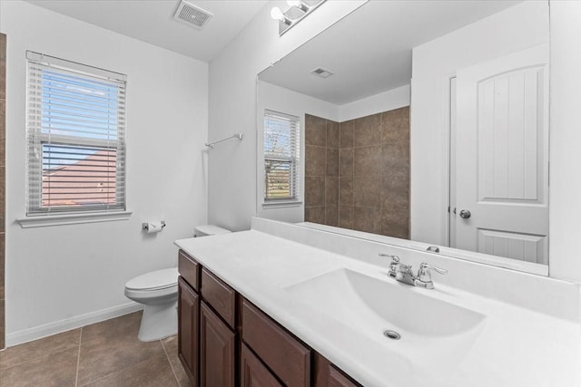 bathroom with visible vents, toilet, tile patterned flooring, baseboards, and vanity