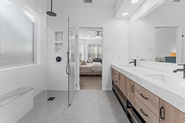 full bath with a sink, double vanity, a walk in shower, and connected bathroom