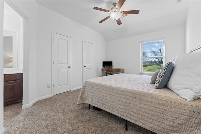 bedroom with carpet flooring, ceiling fan, baseboards, and vaulted ceiling