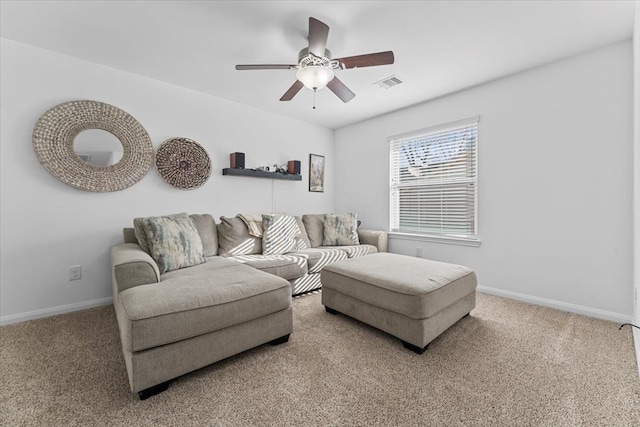 carpeted living area with baseboards, visible vents, and ceiling fan