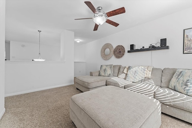 carpeted living room with baseboards and ceiling fan