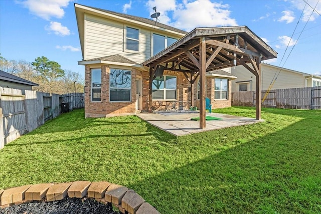 back of house with a patio, a yard, a fenced backyard, and brick siding