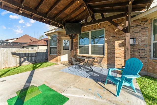 view of patio featuring outdoor dining space and fence