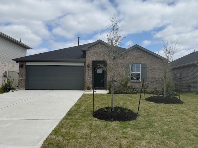 single story home featuring a front yard, driveway, roof with shingles, an attached garage, and brick siding