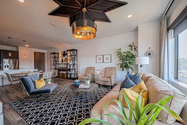 living area with recessed lighting, visible vents, and dark wood-style flooring