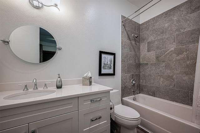 bathroom with tub / shower combination, toilet, and vanity