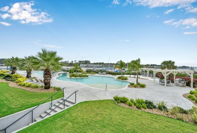 view of swimming pool with a yard and a pergola