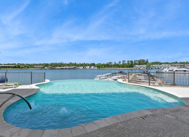 view of pool with fence, a fenced in pool, and a water view