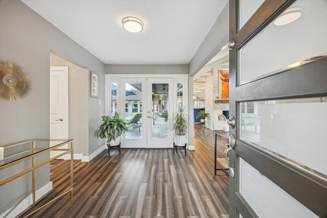 foyer entrance featuring french doors, baseboards, and wood finished floors