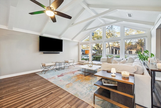 living area featuring visible vents, baseboards, ceiling fan, wood finished floors, and high vaulted ceiling