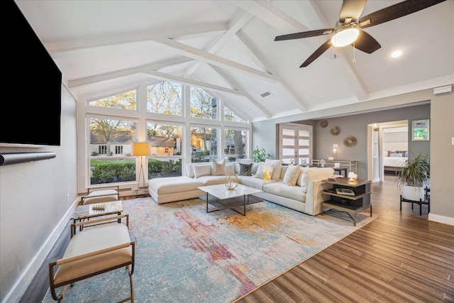 living area featuring a wealth of natural light, visible vents, ceiling fan, and wood finished floors