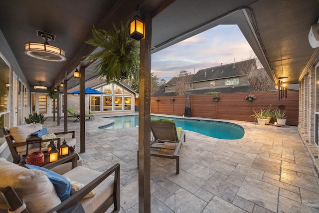 view of pool with a patio area, a fenced backyard, a fenced in pool, and an outdoor structure