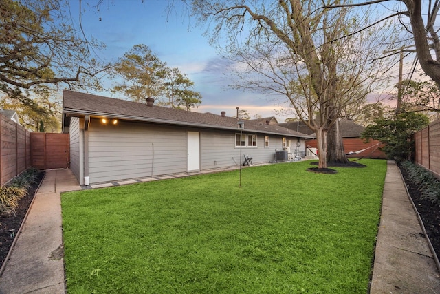 view of yard featuring central AC and a fenced backyard