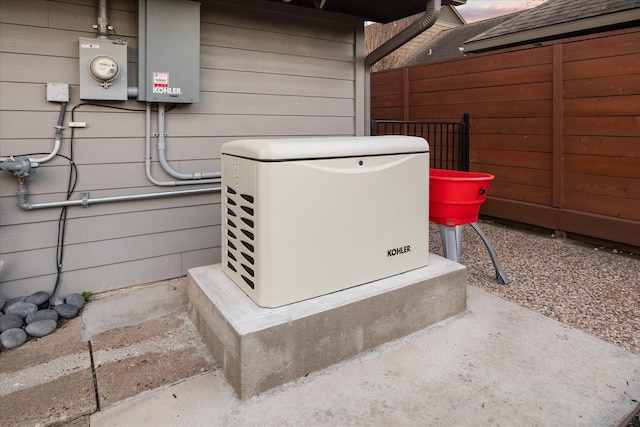 details featuring a power unit, electric meter, and fence