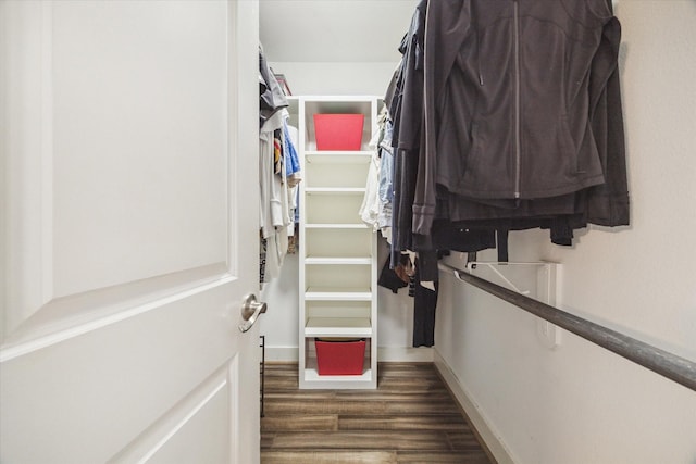 walk in closet with wood finished floors