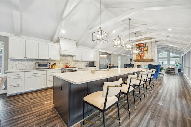 kitchen featuring a sink, range, and white cabinetry