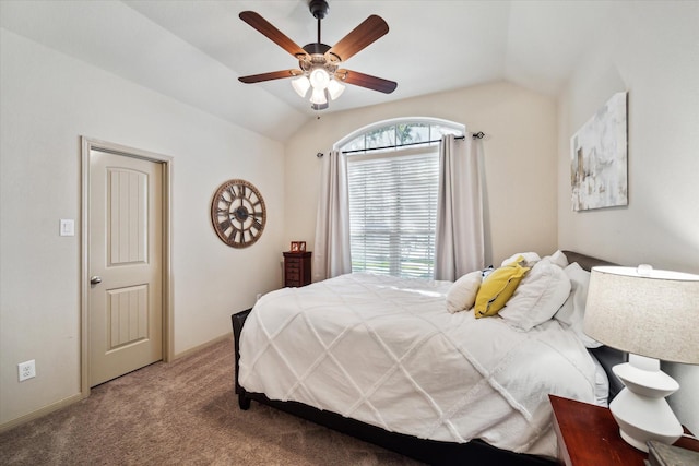 carpeted bedroom with ceiling fan and vaulted ceiling