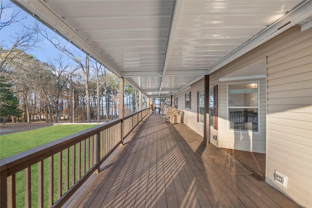 wooden terrace featuring a yard