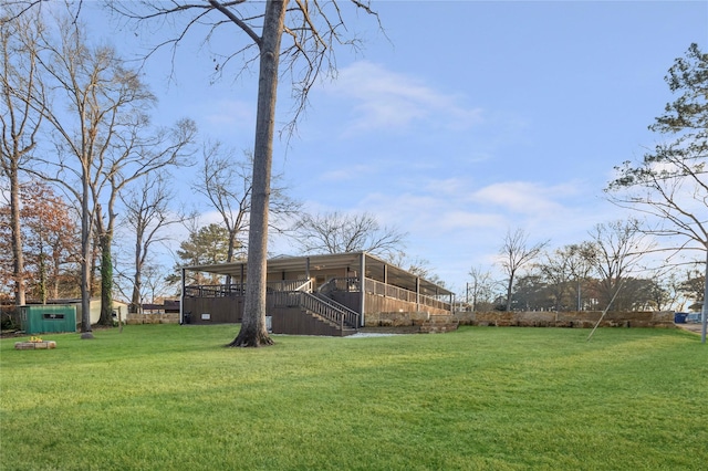 view of yard featuring stairway, an outdoor structure, and a wooden deck