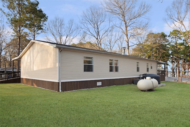 view of side of home with a yard and central AC unit