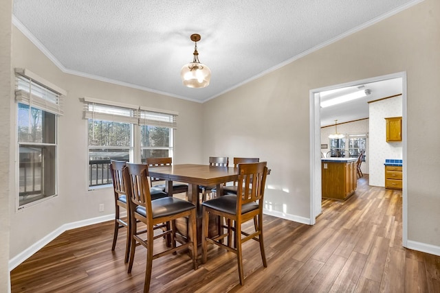 dining space featuring a notable chandelier, dark wood-style flooring, and crown molding