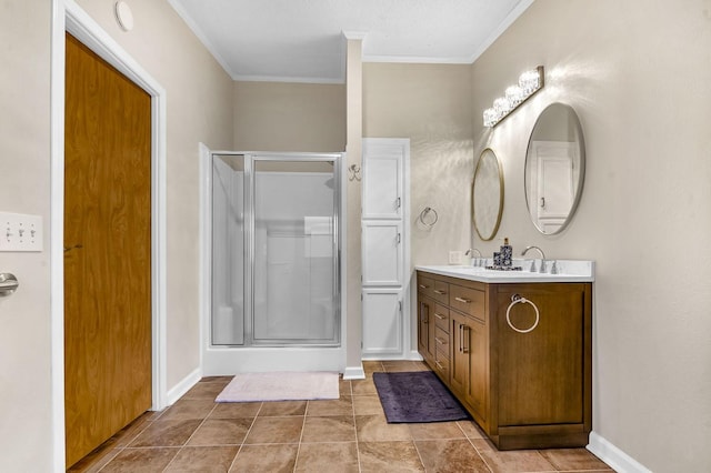 bathroom featuring a shower stall, baseboards, ornamental molding, and double vanity