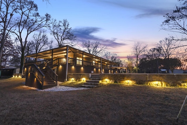 back of property at dusk with stairs