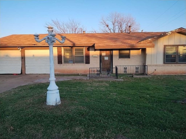 ranch-style house with a garage, driveway, brick siding, and a front lawn