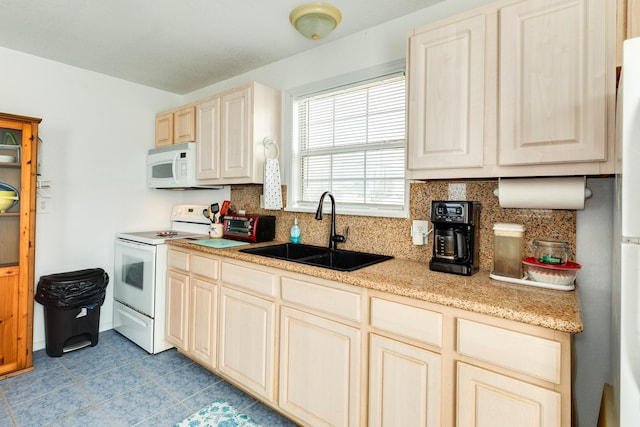 kitchen with tasteful backsplash, white appliances, and a sink