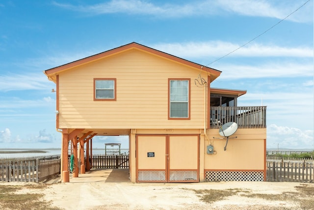 exterior space featuring a carport and fence