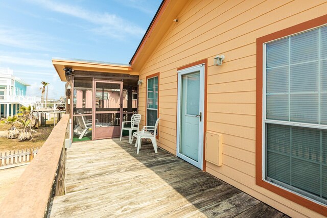 wooden deck with a sunroom