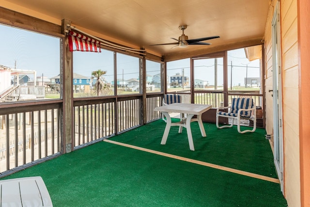 sunroom with a ceiling fan