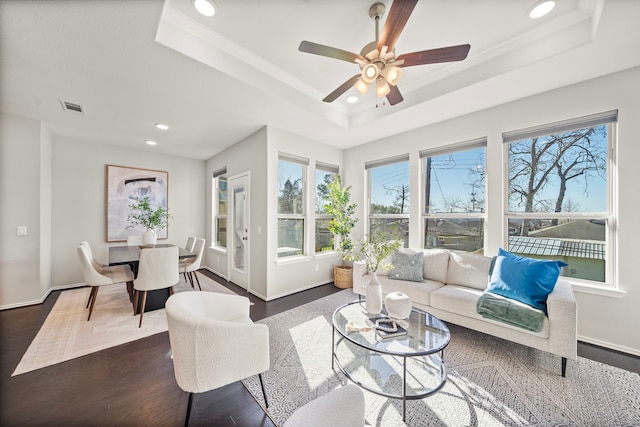 living room with visible vents, ornamental molding, recessed lighting, a raised ceiling, and dark wood-style flooring