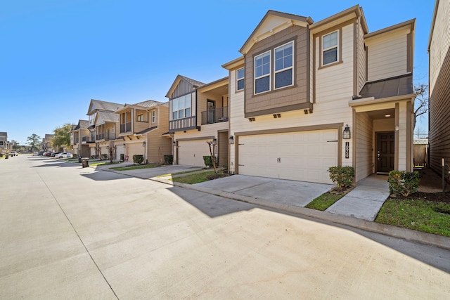 multi unit property featuring a garage, a residential view, and driveway