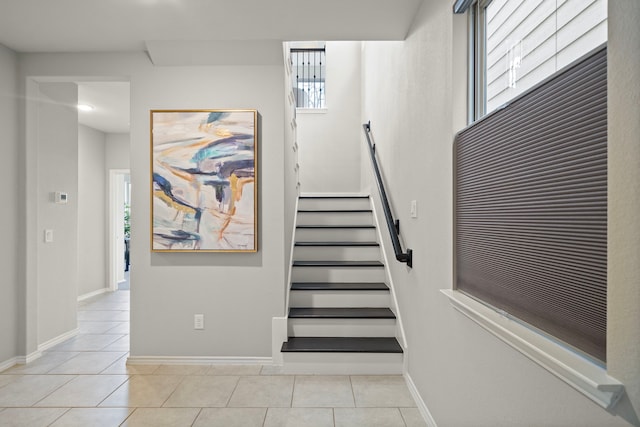 stairs with tile patterned floors and baseboards