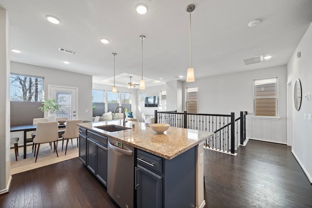 kitchen with visible vents, decorative light fixtures, dishwasher, dark wood-style floors, and a sink