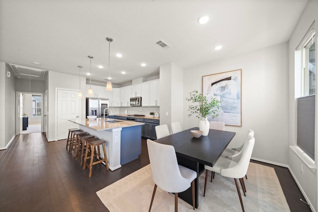 dining space with attic access, recessed lighting, dark wood-style floors, and visible vents